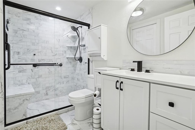 bathroom featuring vanity, toilet, and a shower with door