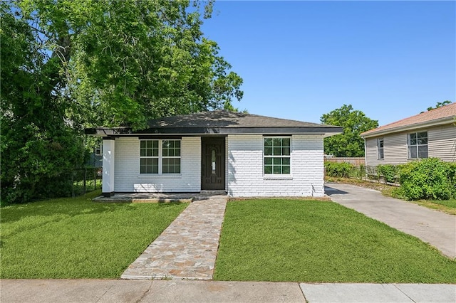 8014 Lucerne St, New Orleans, LA 70128 - view of front facade with brick siding and a porch