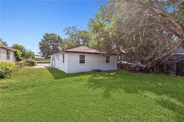 8014 Lucerne St, New Orleans, LA 70128 - rear view of house with a yard and brick siding