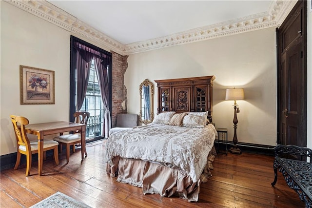 bedroom with crown molding and hardwood / wood-style floors