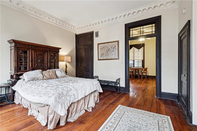 bedroom featuring dark hardwood / wood-style flooring and ornamental molding