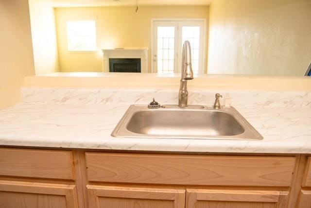 interior space featuring sink and light brown cabinetry