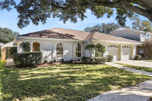 view of front of home with a front yard and a garage