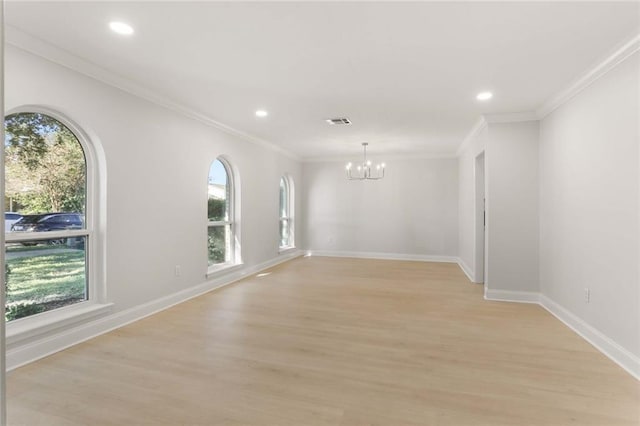 unfurnished room with plenty of natural light, crown molding, and light hardwood / wood-style flooring