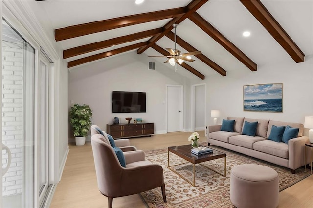 living room featuring ceiling fan, beam ceiling, and light wood-type flooring