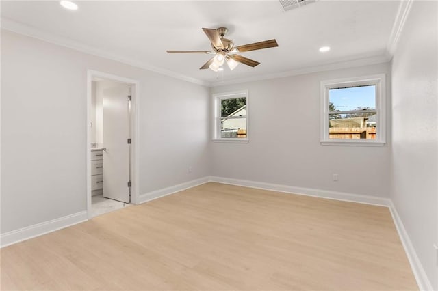 spare room featuring light hardwood / wood-style floors, ceiling fan, and crown molding