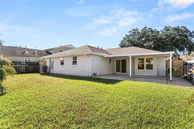 back of house featuring a patio area, a yard, and central AC