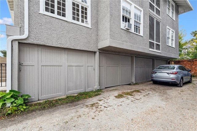 view of side of property with cooling unit and stucco siding