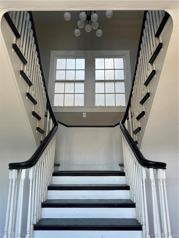 staircase with a towering ceiling