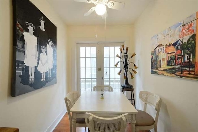 dining area with hardwood / wood-style flooring, ceiling fan, and french doors