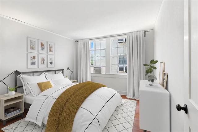 bedroom with light hardwood / wood-style flooring and cooling unit