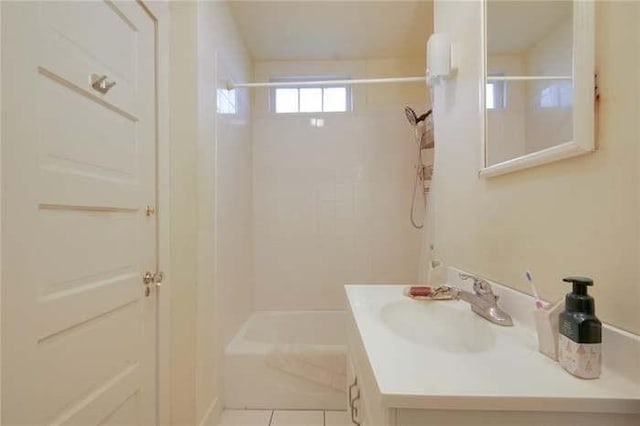 bathroom with vanity, tile patterned floors, and washtub / shower combination