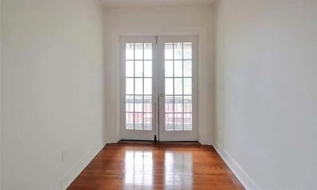 entryway with french doors and light hardwood / wood-style flooring