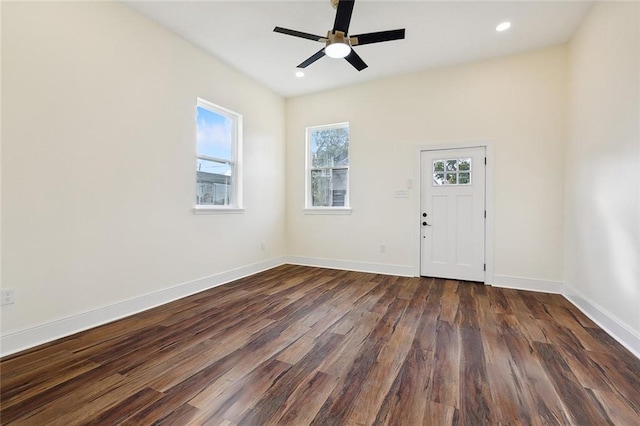 unfurnished room with ceiling fan and dark wood-type flooring