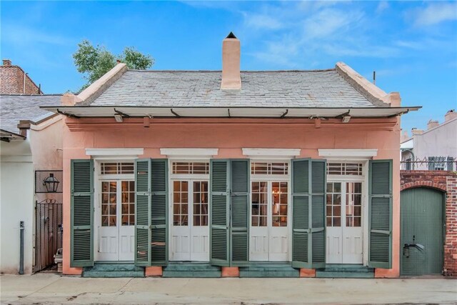 625 Dumaine St, New Orleans, LA 70116 - back of house featuring a chimney, a high end roof, and entry steps