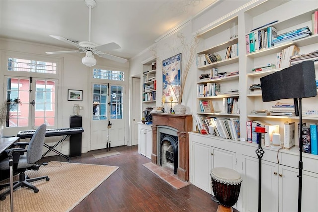 office area featuring built in shelves, ceiling fan, french doors, dark hardwood / wood-style floors, and ornamental molding