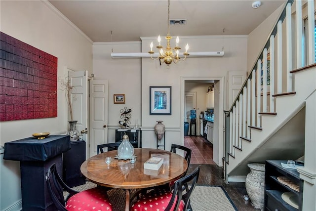 dining area featuring crown molding, dark hardwood / wood-style flooring, and a notable chandelier