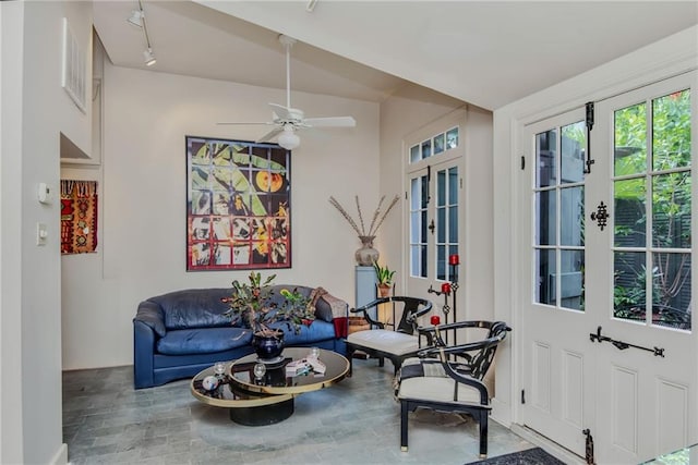 sitting room featuring ceiling fan, french doors, track lighting, and lofted ceiling