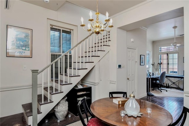 dining area with crown molding, ceiling fan with notable chandelier, and dark hardwood / wood-style floors