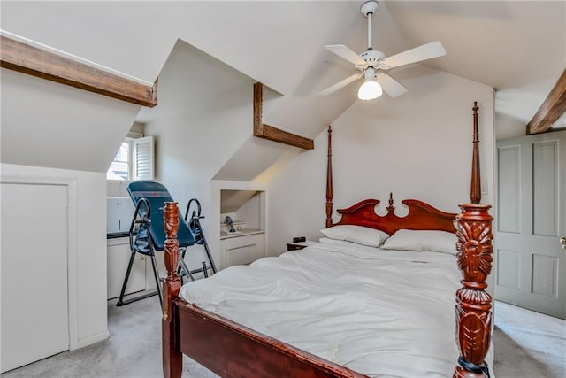 carpeted bedroom with lofted ceiling with beams and ceiling fan