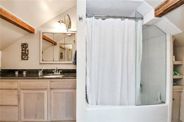 bathroom featuring shower / bathtub combination with curtain, vanity, and vaulted ceiling