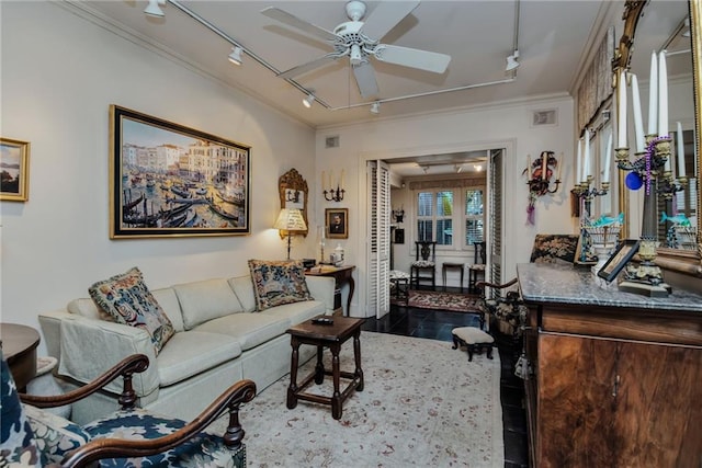 living room with dark hardwood / wood-style floors, ceiling fan, ornamental molding, and track lighting