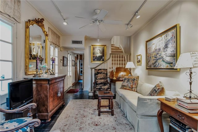 sitting room featuring rail lighting, dark hardwood / wood-style floors, ceiling fan, and crown molding