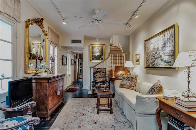 625 Dumaine St, New Orleans, LA 70116 - living room with track lighting, crown molding, a ceiling fan, stairs, and plenty of natural light