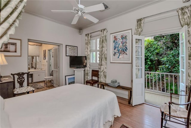 bedroom with hardwood / wood-style floors, ensuite bath, ceiling fan, and crown molding