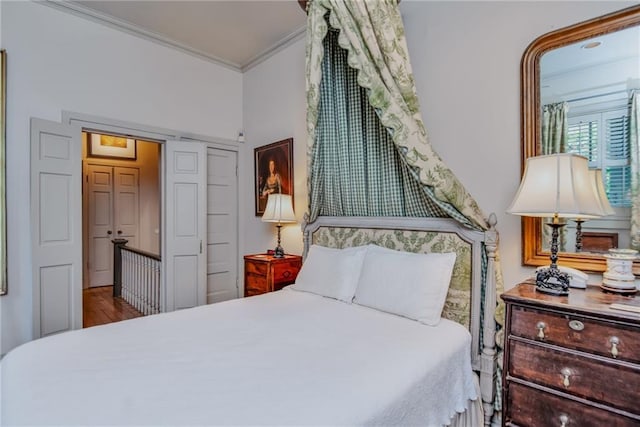 bedroom with hardwood / wood-style floors and crown molding