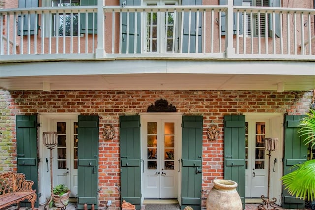 entrance to property featuring french doors and a balcony