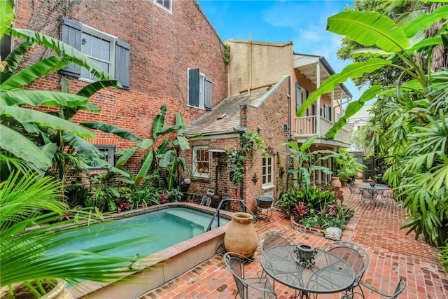 625 Dumaine St, New Orleans, LA 70116 - view of pool featuring a patio, a hot tub, and outdoor dining space