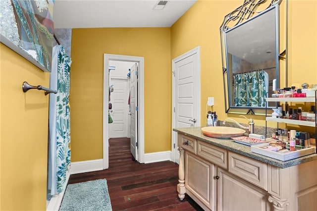 bathroom with lofted ceiling, vanity, and hardwood / wood-style flooring