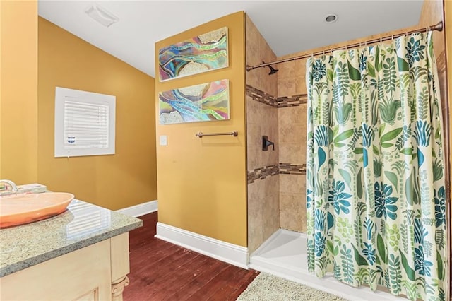 bathroom with hardwood / wood-style flooring, vaulted ceiling, vanity, and a shower with shower curtain