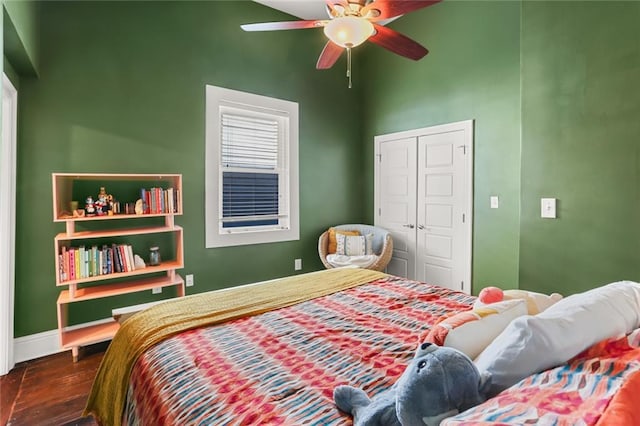 bedroom with ceiling fan, a closet, and dark hardwood / wood-style flooring