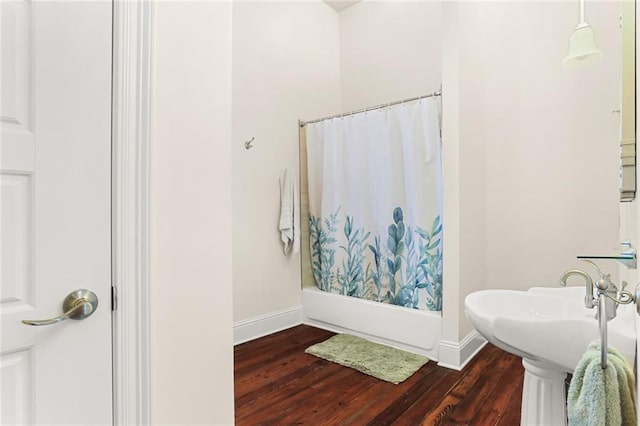 bathroom featuring hardwood / wood-style flooring and shower / tub combo with curtain