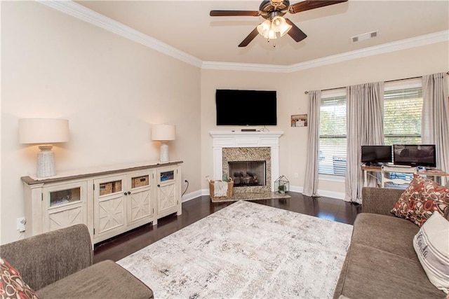 living room featuring a premium fireplace, ceiling fan, dark hardwood / wood-style floors, and ornamental molding