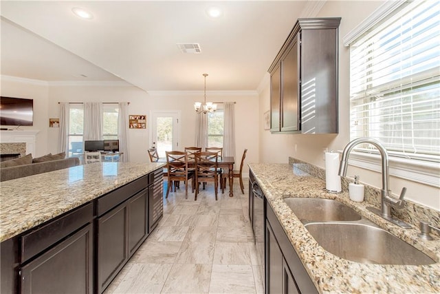 20291 Clemson Way, Ponchatoula, LA 70454 - kitchen featuring a sink, a chandelier, dark brown cabinetry, open floor plan, and crown molding