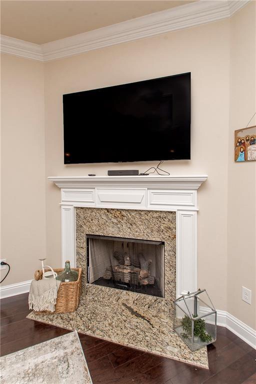 20291 Clemson Way, Ponchatoula, LA 70454 - detailed view of a high end fireplace, wood finished floors, baseboards, and crown molding