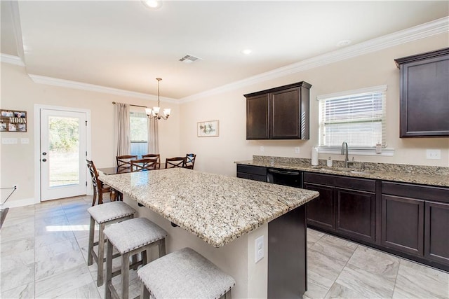 kitchen with decorative light fixtures, a center island, sink, and crown molding