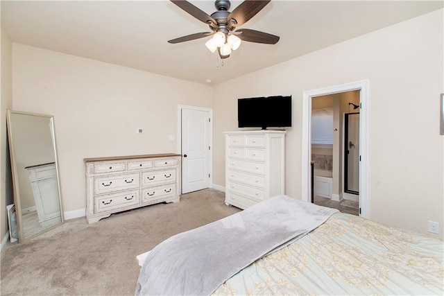 carpeted bedroom with ensuite bath and ceiling fan