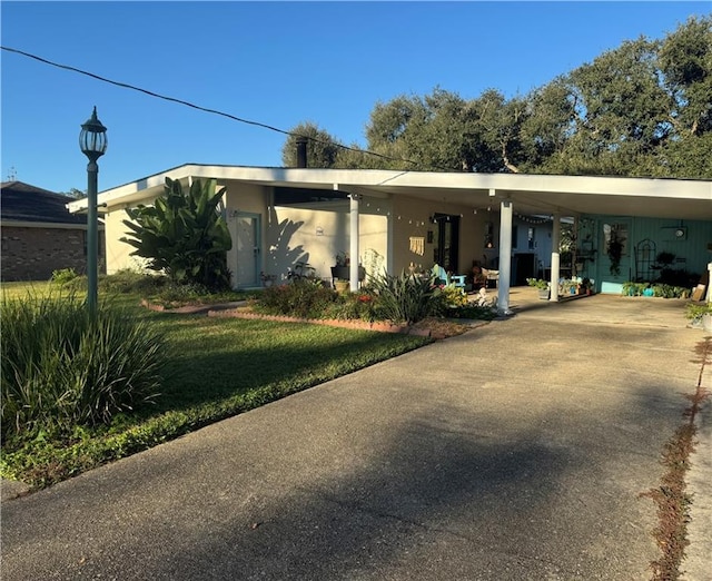 ranch-style house with a front lawn and a carport