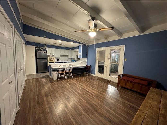 kitchen with white cabinetry, lofted ceiling with beams, stainless steel appliances, and dark hardwood / wood-style floors