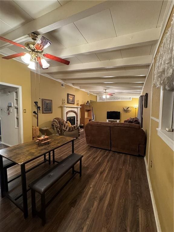 dining room featuring beam ceiling, ceiling fan, and dark wood-type flooring