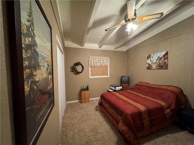 carpeted bedroom with beamed ceiling and ceiling fan