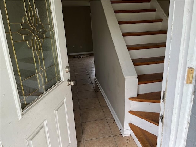 stairs featuring tile patterned flooring