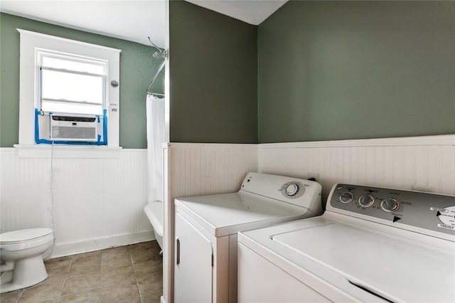 laundry area with light tile patterned flooring, washing machine and dryer, and cooling unit