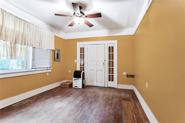 interior space with ceiling fan, dark hardwood / wood-style flooring, and heating unit