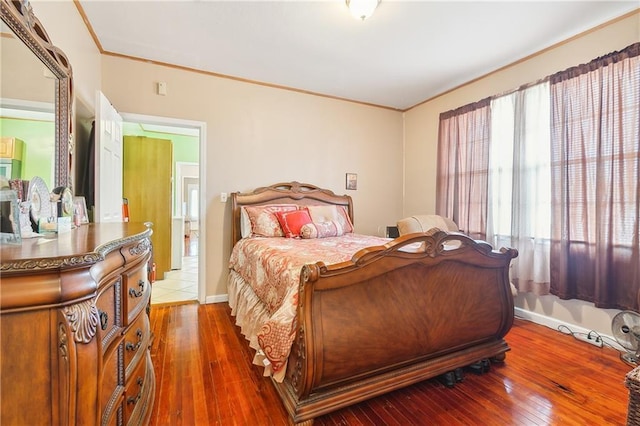 bedroom featuring dark hardwood / wood-style flooring and ornamental molding