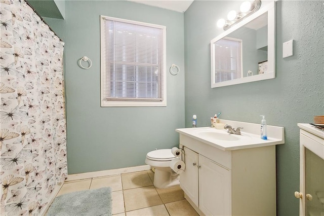 bathroom with a shower with curtain, tile patterned flooring, vanity, and toilet